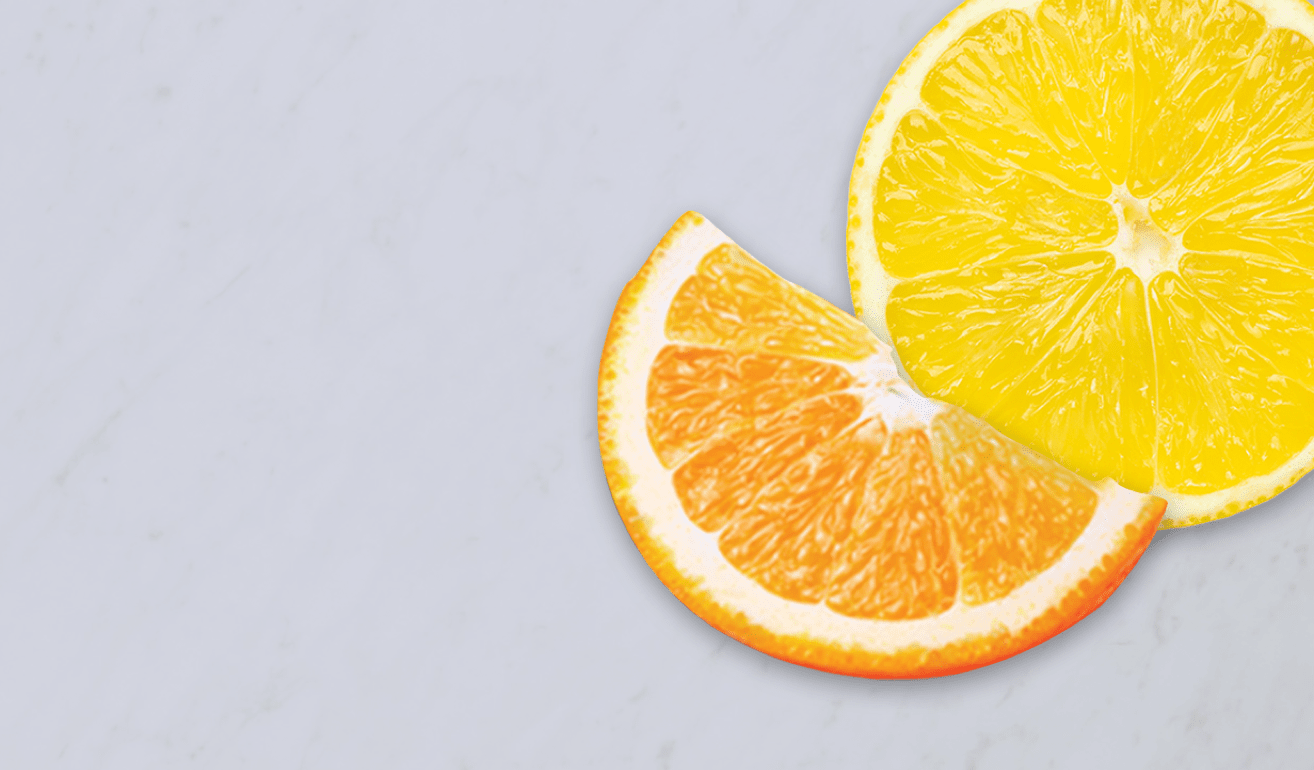 Slices of citrus fruit on a grey background
